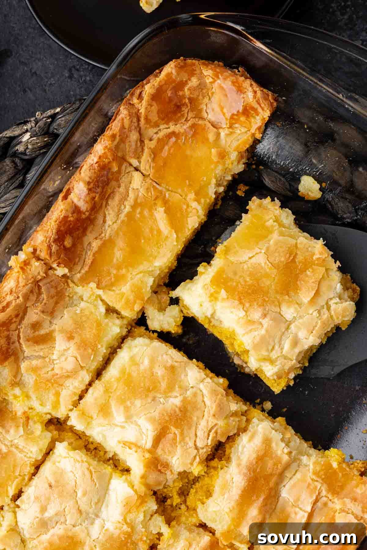 A pan of neatly sliced Southern Chess Squares, showcasing a golden, flaky crust on the bottom and a smooth, creamy topping.