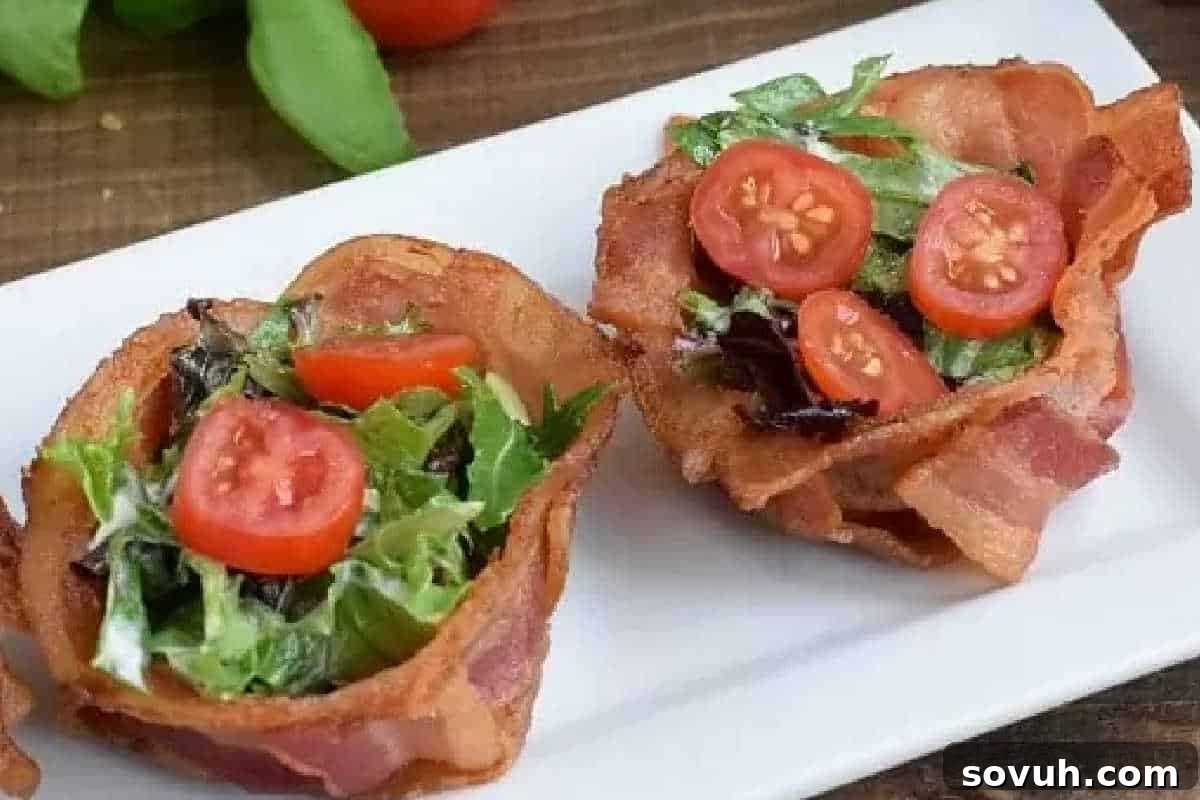 Two bacon cups filled with mixed greens and cherry tomato slices on a white plate, perfect for your Easter brunch favorites.