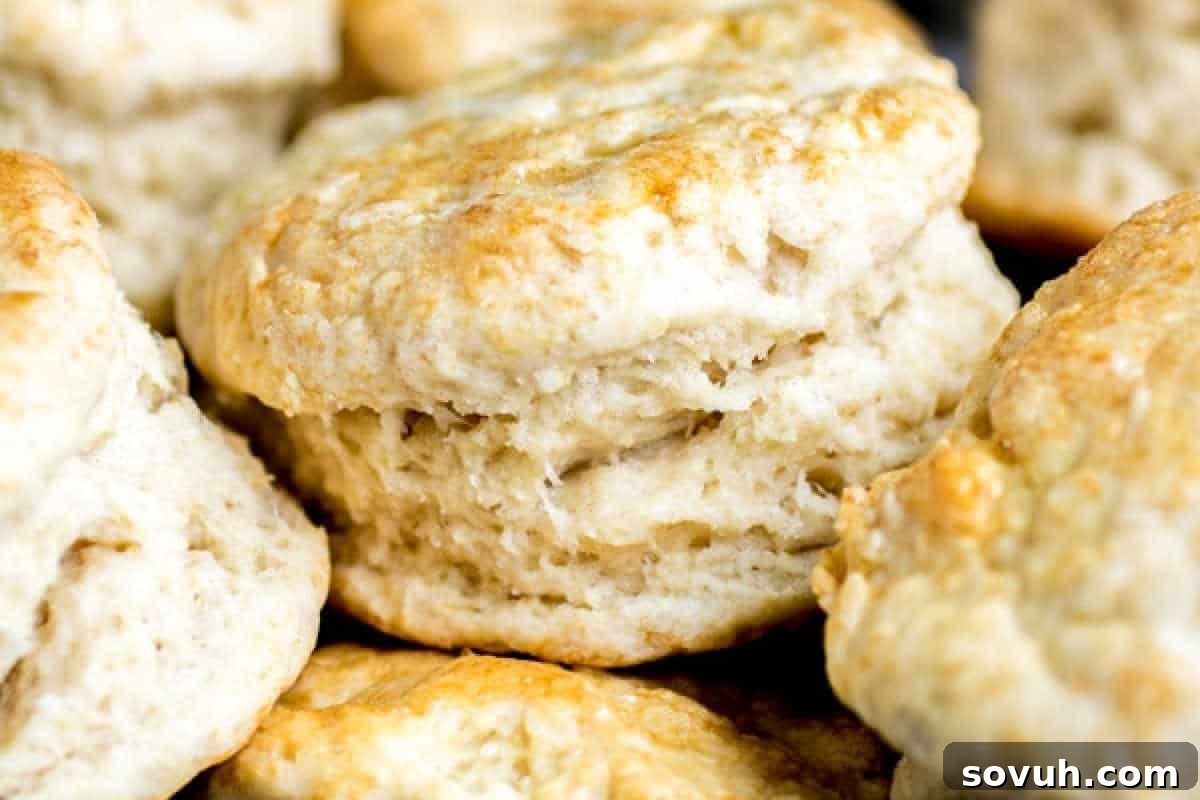 Close-up of a stack of freshly baked, golden-brown biscuits with a flaky texture, perfect for your Easter brunch favorites.