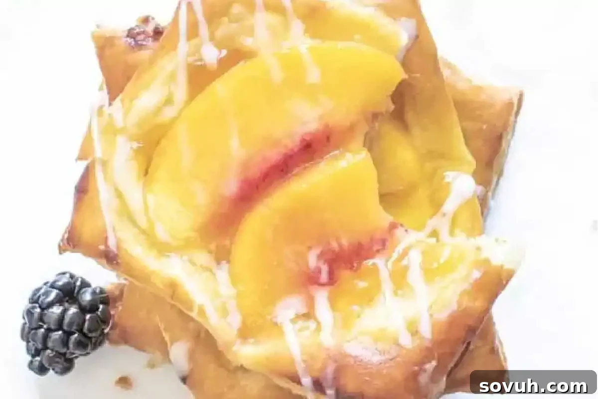 This Easter, delight in a favorite brunch treat: a scrumptious pastry topped with juicy peach slices and a glossy glaze, elegantly served with a blackberry on a pristine white plate.
