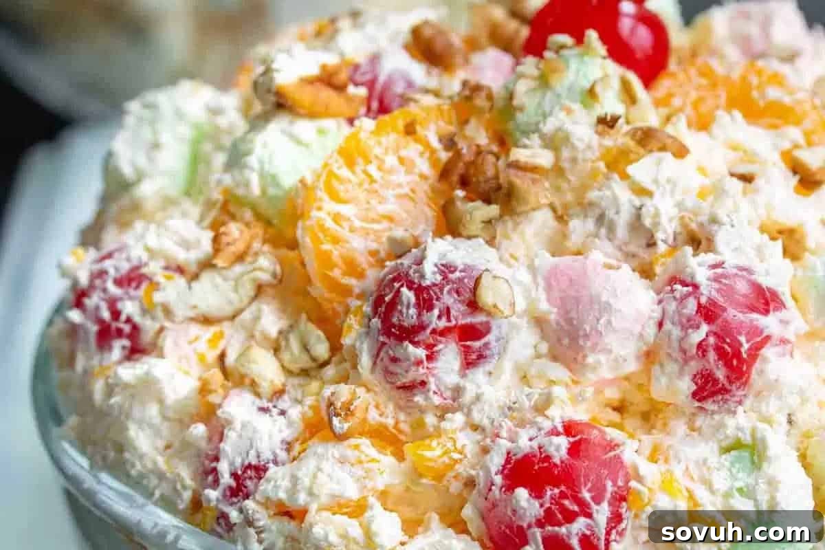 Whimsical Easter Treats Made Simple 14 A close-up of a colorful fruit salad with whipped cream, marshmallows, cherries, mandarin slices, and chopped nuts.