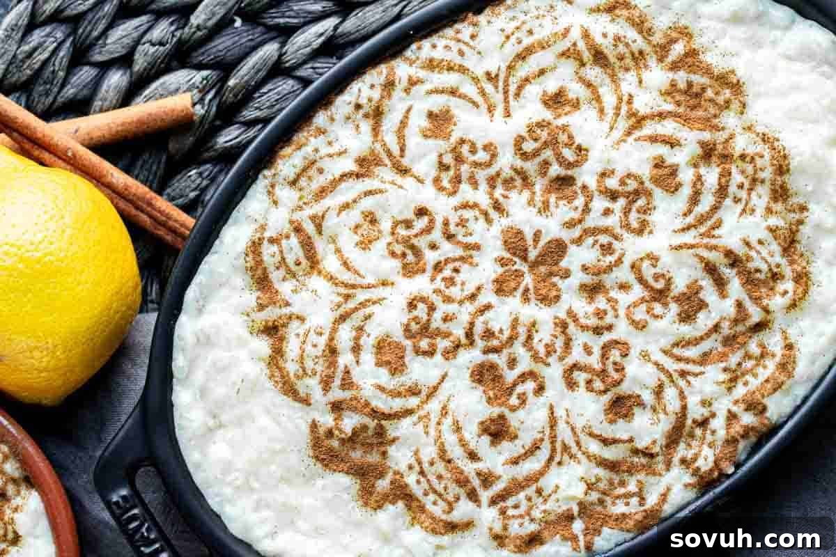 Whimsical Easter Treats Made Simple 15 Decorative cinnamon design on a dish with rice pudding, next to lemons and cinnamon sticks on a textured surface.