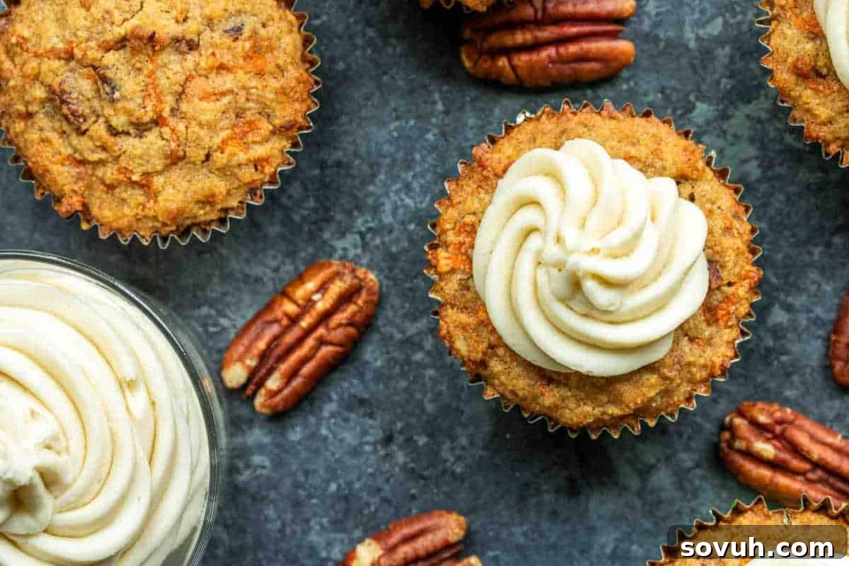 Whimsical Easter Treats Made Simple 16 Cupcakes topped with white frosting are displayed on a dark surface surrounded by pecans.