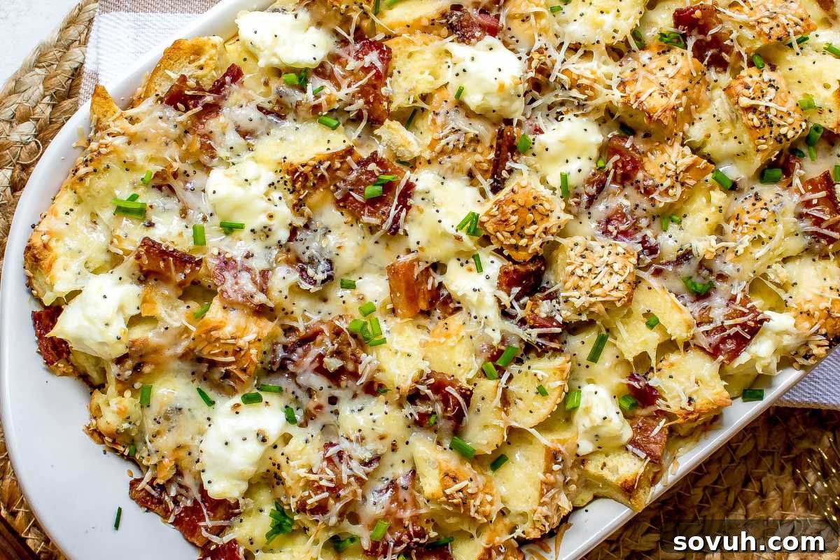 A platter of roasted potatoes topped with melted cheese, bits of crispy bacon, and chopped green onions.