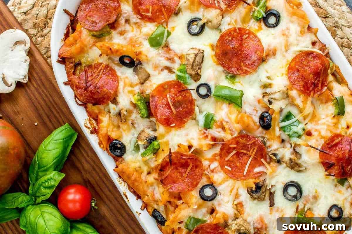 A freshly baked and vibrant pizza casserole, generously topped with savory pepperoni, crisp green peppers, ripe olives, earthy mushrooms, and a bubbling layer of melted cheese, presented on a rustic wooden board alongside fragrant basil leaves and sweet cherry tomatoes.