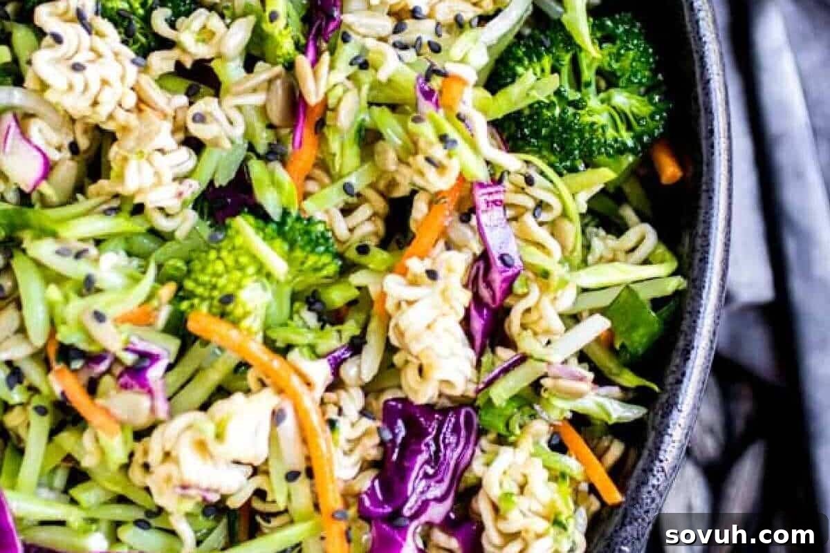 A vibrant Ramen Noodle Salad presented in a pristine white bowl, ready to be enjoyed.