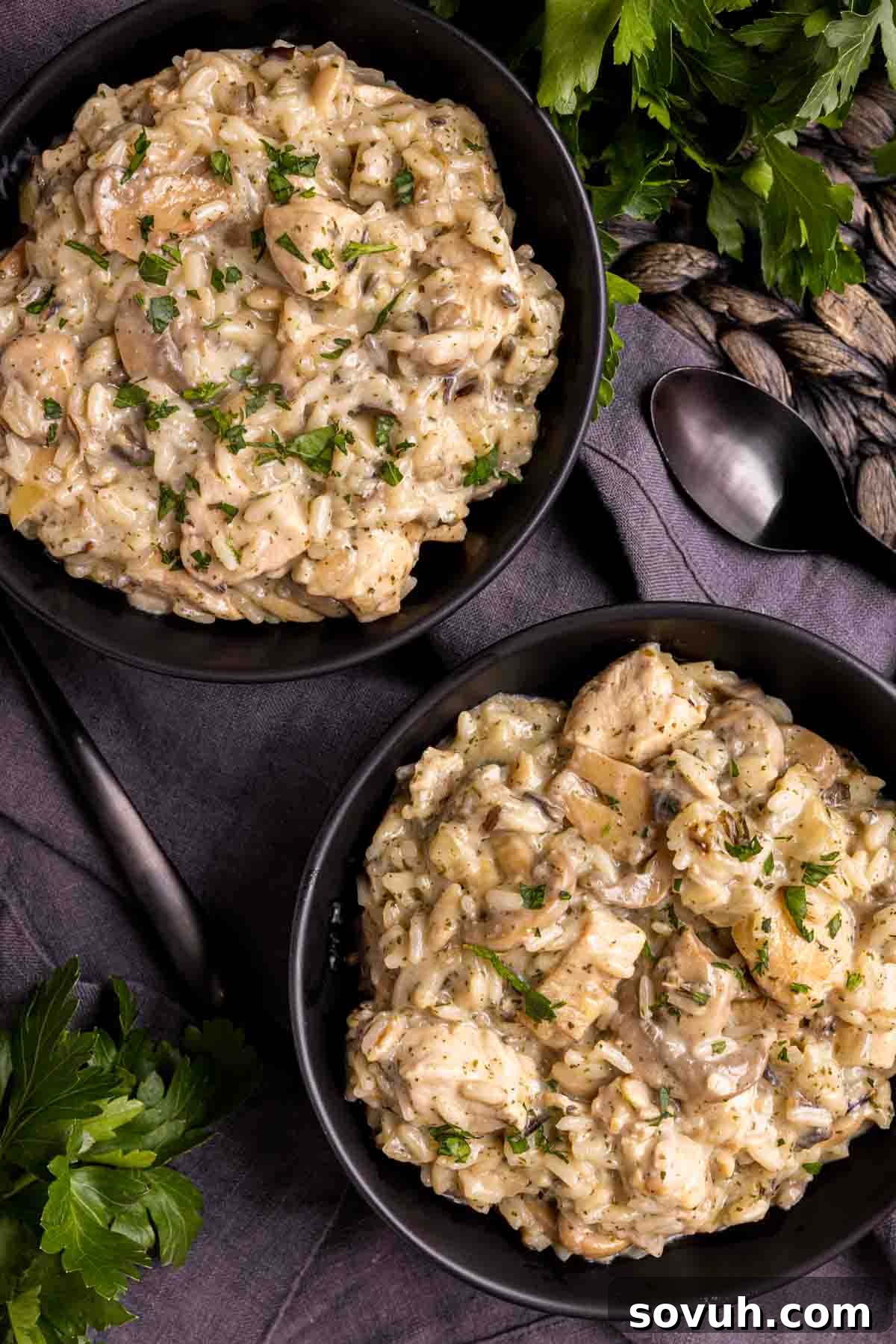 Two black bowls filled with Cream of Mushroom Chicken and Rice, one in the foreground and one slightly blurred behind
