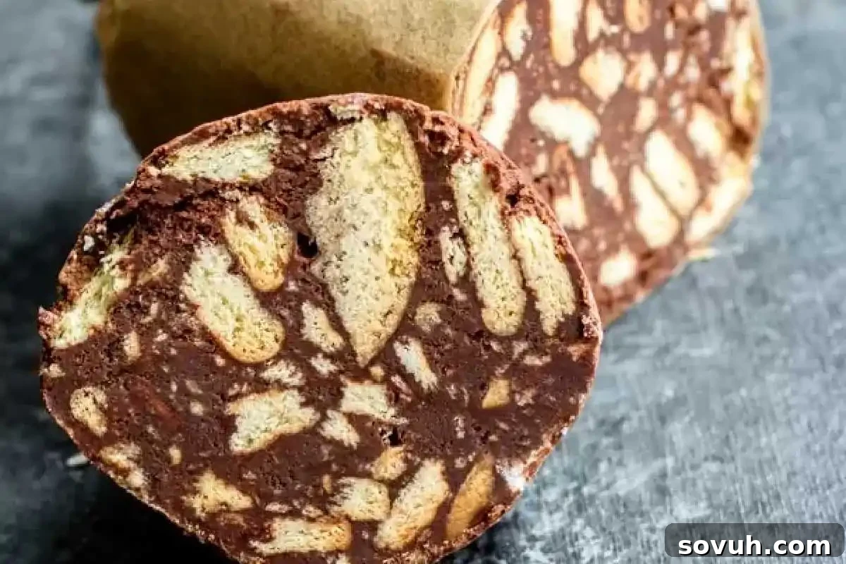 A close-up of a sliced Portuguese Chocolate Salami (Salame de Chocolate), revealing a rich blend of chocolate and crunchy Maria biscuits.