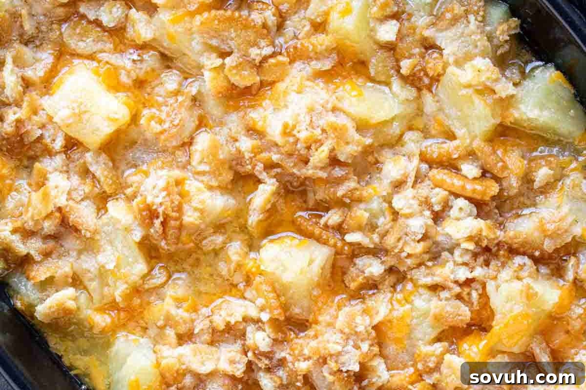 Close-up of a baked pineapple casserole with a crumbly topping.
