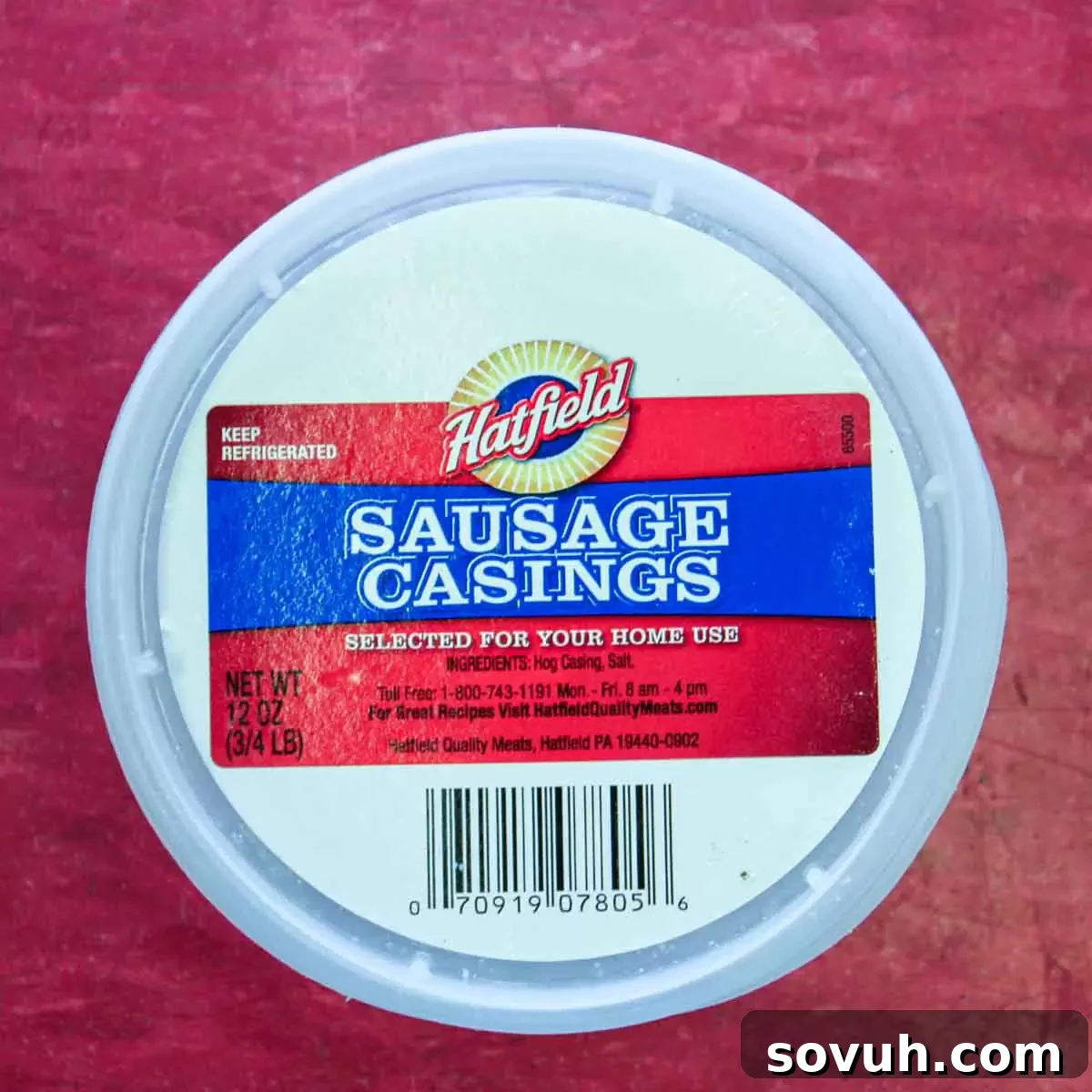 A container of sausage casings on a red surface, essential for making Portuguese sausage