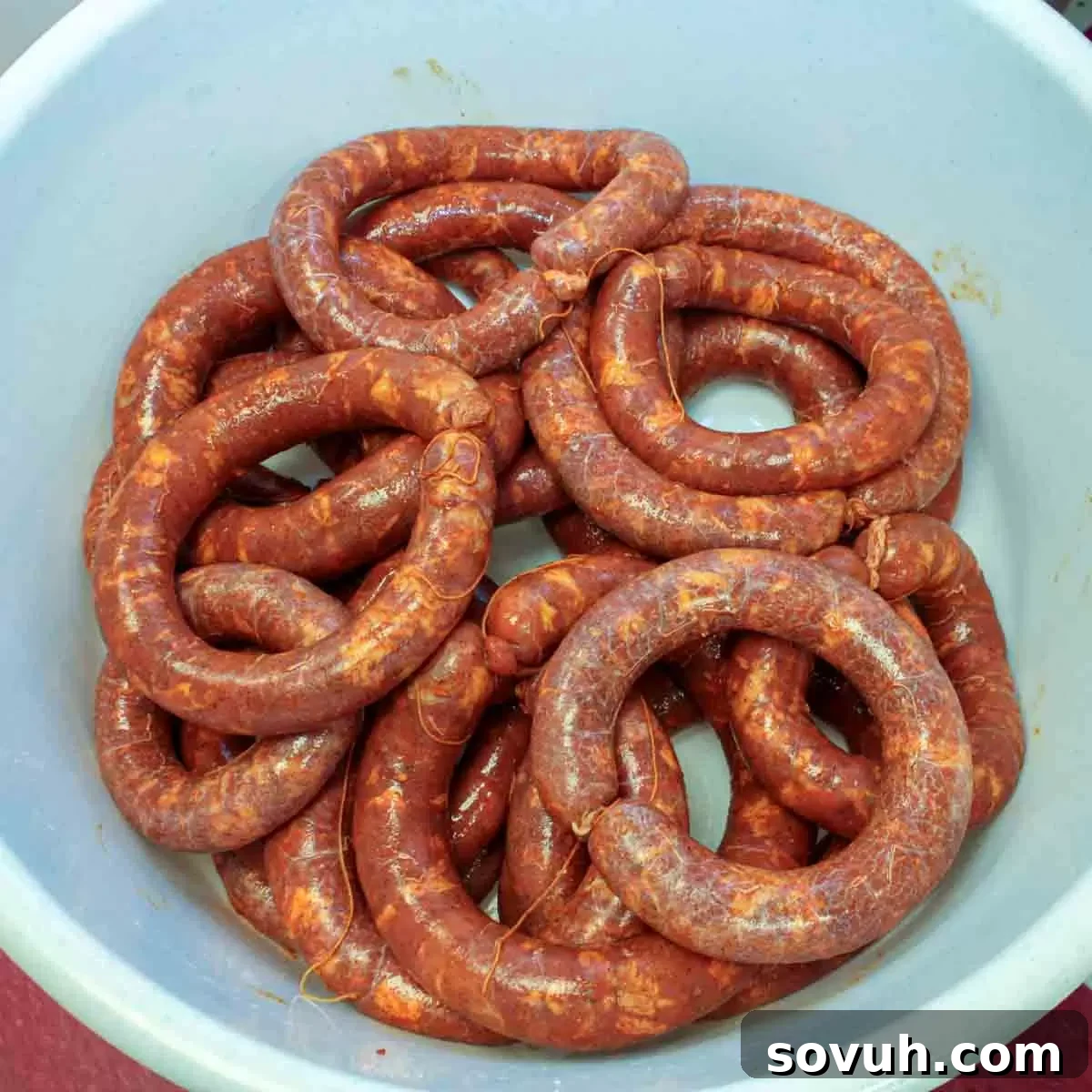 A bowl filled with freshly prepared Portuguese sausages, showcasing the results of the stuffing process