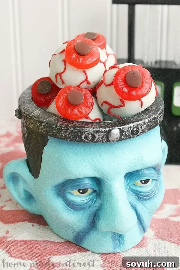 OREO cookie ball eyeballs with gummy candies and red chocolate veins, displayed for a Halloween Mad Scientist Party.