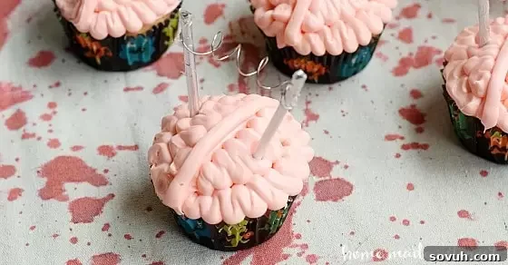Mental Morsels 4 These creepy brain cupcakes are what every mad scientist wants at his Halloween Party. Tutorial for how to frost the cupcakes and a simple DIY Halloween cupcake topper.