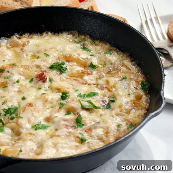 Wow your friends with this easy Caramelized Onion and Bacon Skillet Dip. This is a perfect dip recipe for parties or a great Father’s Day recipe. Sweet onions and salty bacon mixed with lots of melted cheese make this dip rich, smokey and ooey gooey delicious!