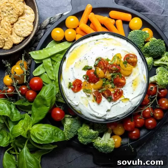 Whipped Ricotta and Tomato Dip in a bowl on a vegetable platter