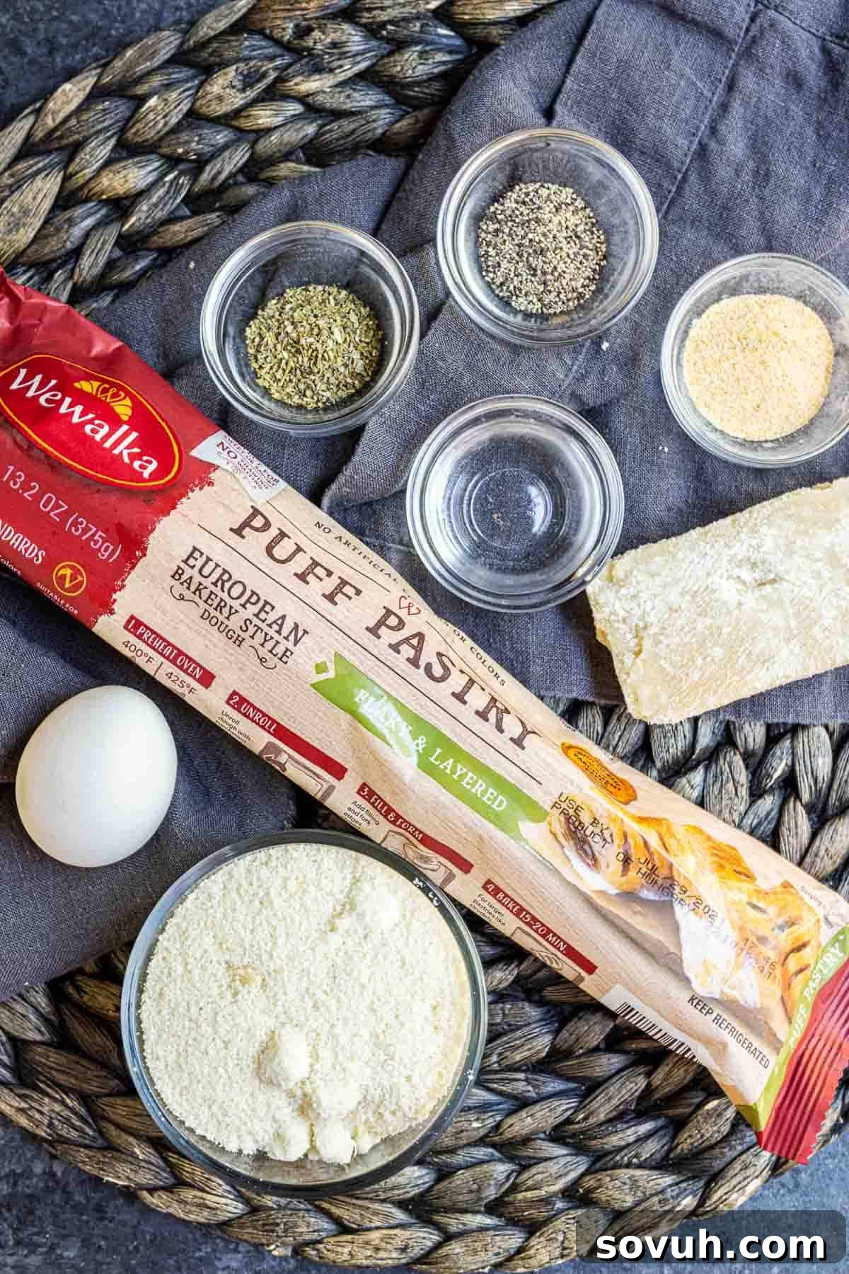 Assortment of fresh ingredients for Cheese Twists, including puff pastry, cheeses, and spices.