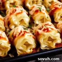 A baking dish filled with mini lasagna appetizer, golden and bubbly.