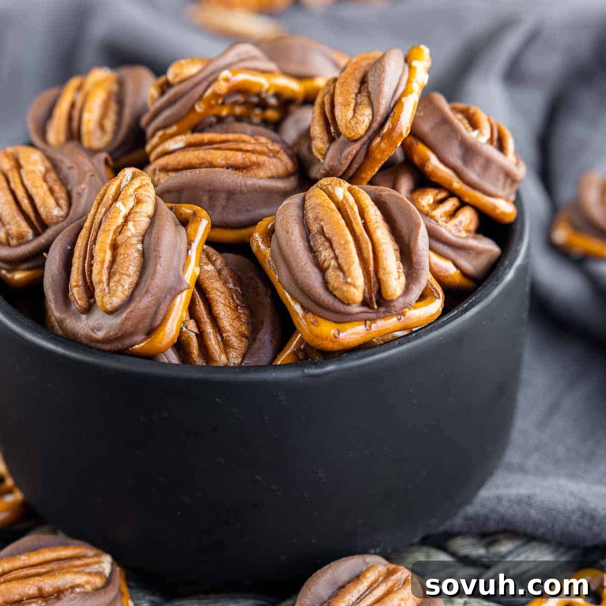 Delicious Rolo Pretzel Turtle Candy in a black bowl, perfect for holiday gifting or easy dessert