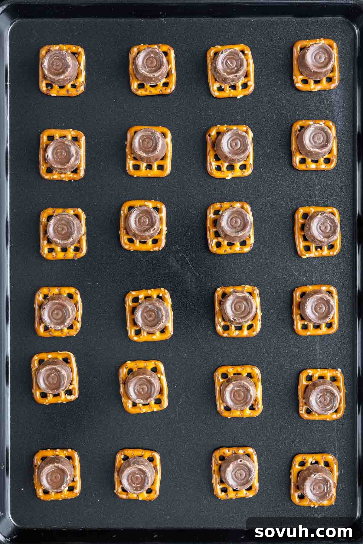 Step-by-step image showing how to place Rolos on mini pretzels for turtle candy