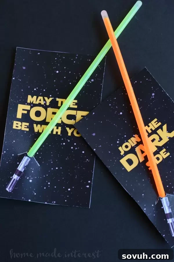 Close-up of DIY Lightsaber party favors, showcasing the printable design and glow stick