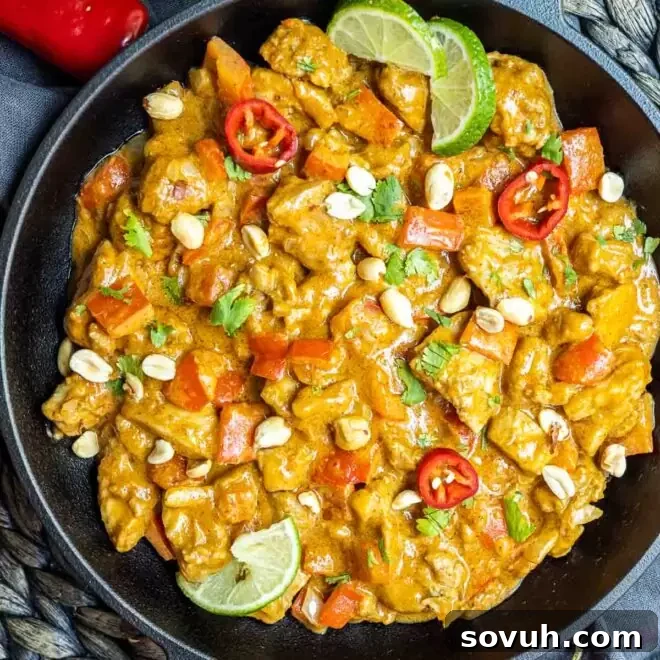 Keto Peanut Butter Chicken served in a cast iron skillet, garnished with fresh cilantro.