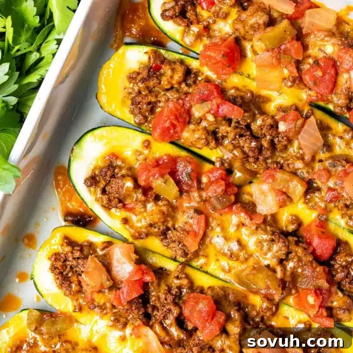 Rotel-topped Taco Zucchini Boats in a baking dish, garnished with fresh cilantro.