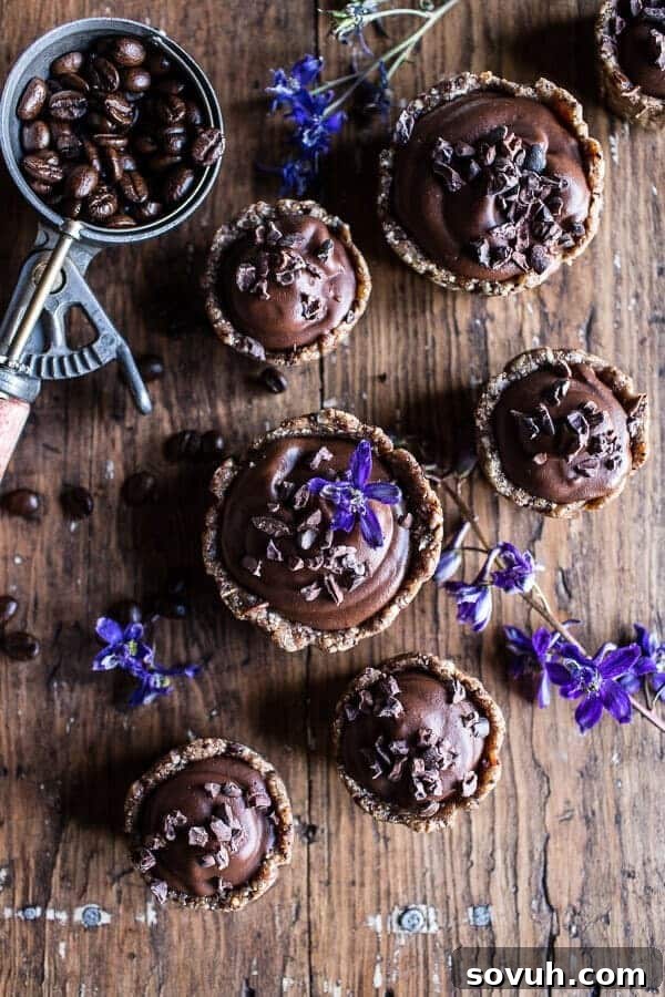 Chocolate and coffee tarts on a wooden table.