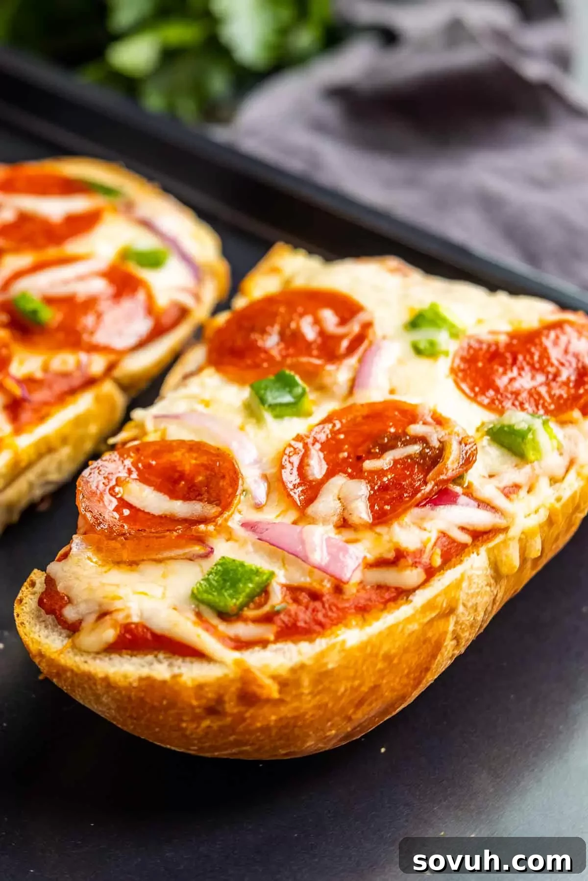 French Bread Pizza with pepperoni and green peppers, freshly baked and ready to eat.