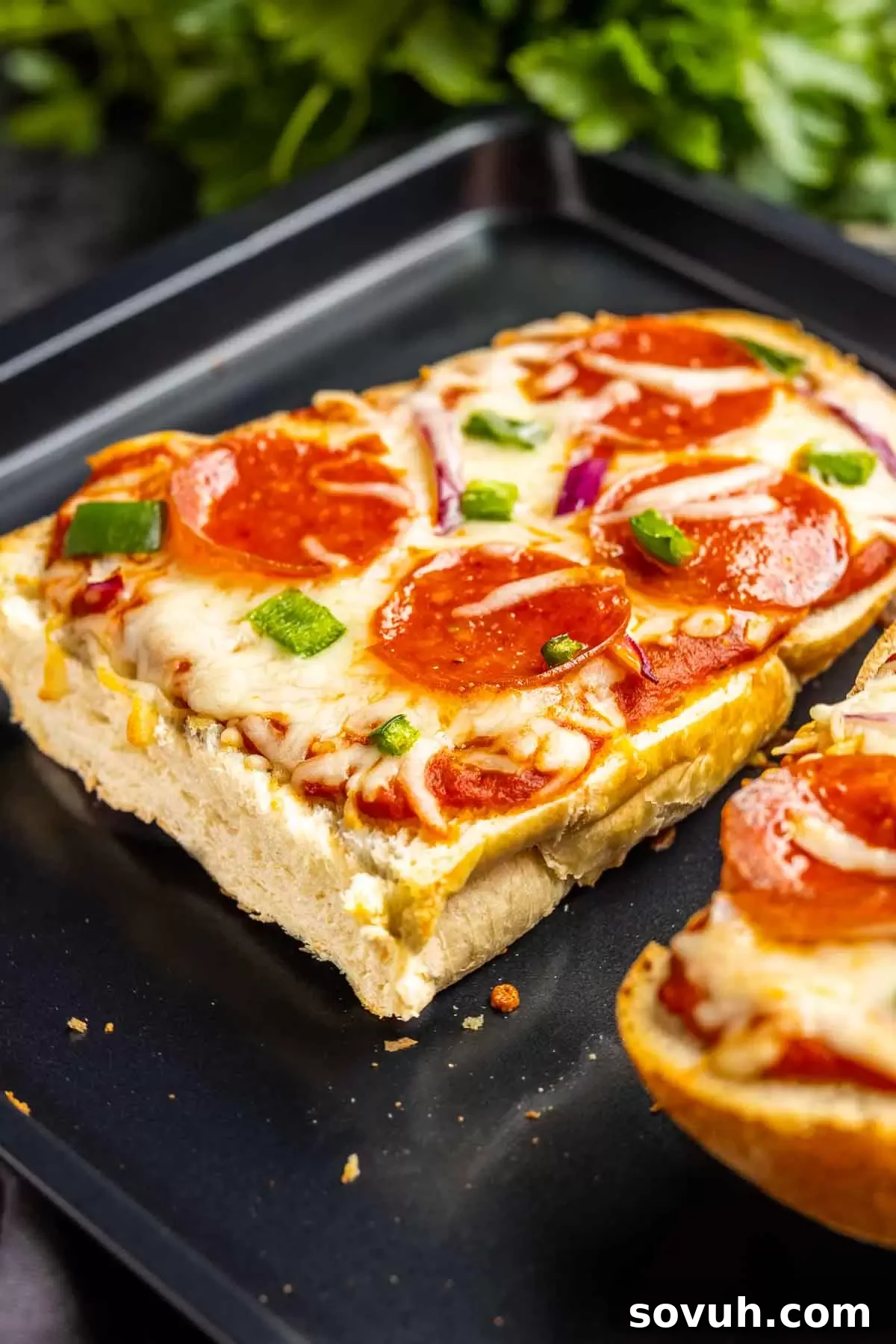 French Bread Pizza topped with pepperoni slices on a baking sheet.
