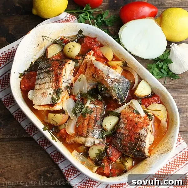 A vibrant close-up of the finished Portuguese-style Baked Rockfish dish, presented in a rustic baking pan. The golden-brown fish fillets are surrounded by tender potatoes, ripe tomatoes, and onions, all infused with aromatic spices. This healthy, low-calorie, low-carb, and low-fat seafood recipe is perfect for any occasion.