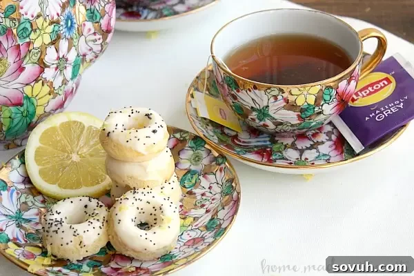 Close-up of baked mini lemon poppy seed donuts, ready for glazing, ideal for a special brunch.