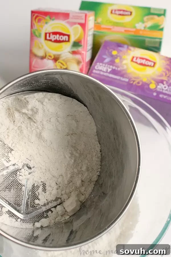Ingredients for mini lemon poppy seed donuts, including flour, sugar, and lemon zest, laid out for baking.