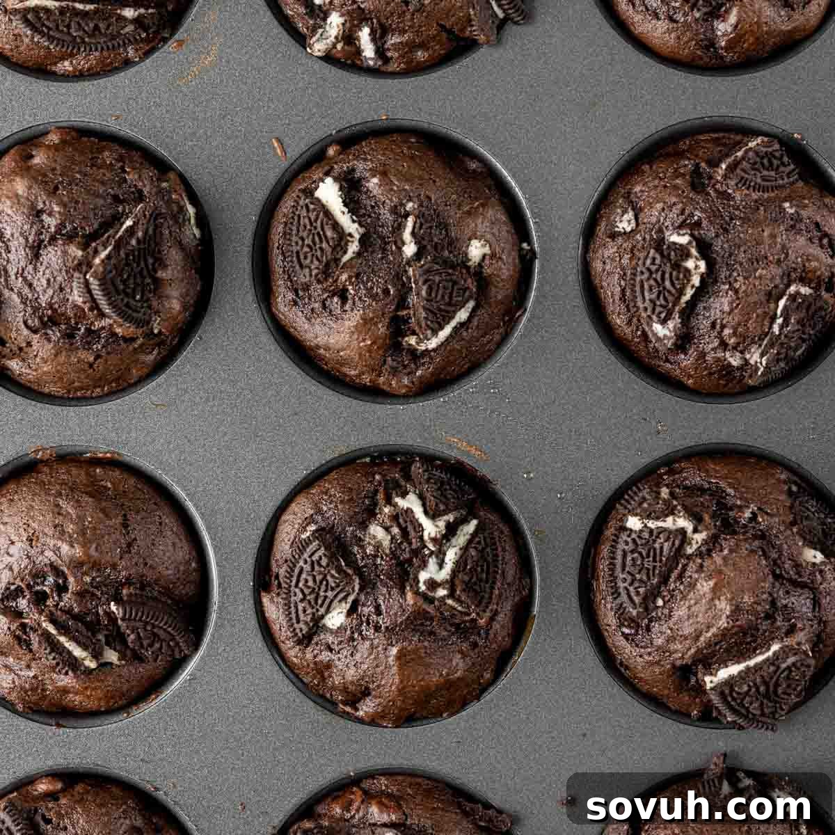 Chocolate Oreo Muffins in a muffin tin, a decadent breakfast treat with a crumble topping.