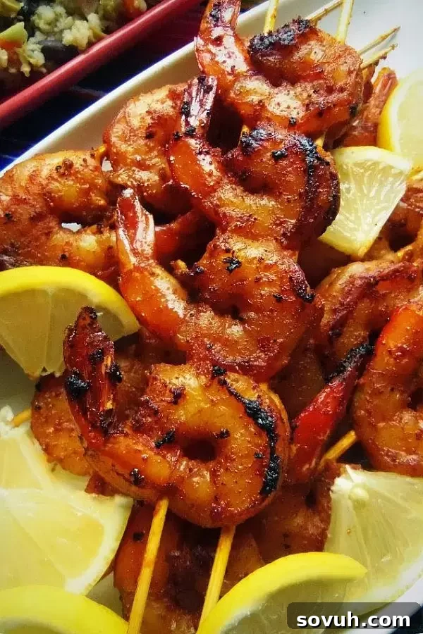 Tito's Spiked Bloody Mary Chipotle Shrimp, a vibrant and spicy seafood dish with fresh herbs.