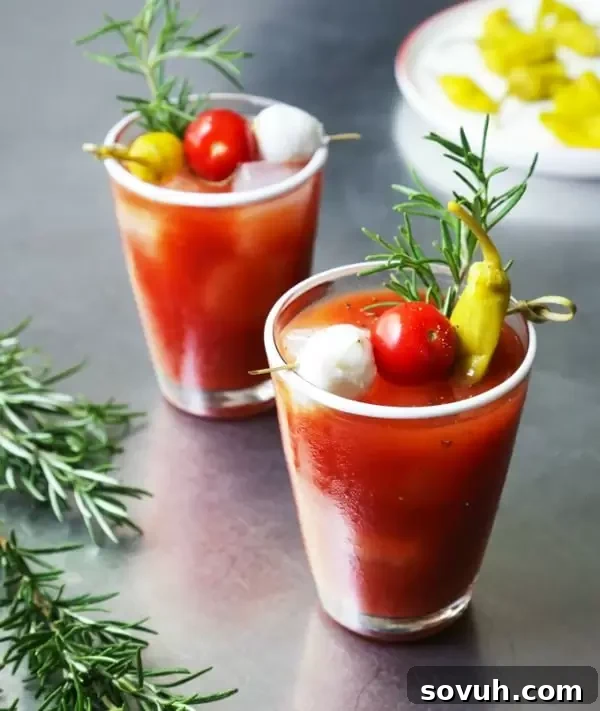 An aromatic Roasted Garlic Bloody Mary, garnished with roasted garlic cloves and fresh herbs.