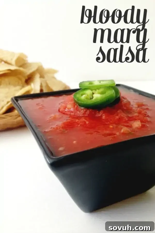 Fresh and zesty Bloody Mary Salsa, served in a bowl with crispy tortilla chips.