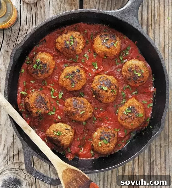 Delectable Bloody Mary Meatballs, coated in a rich, tangy sauce and garnished with fresh parsley.