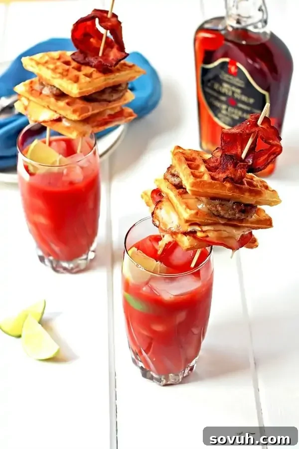 An indulgent Bacon Infused Bloody Mary, topped with a gourmet waffle grilled cheese sandwich, making for a full meal.