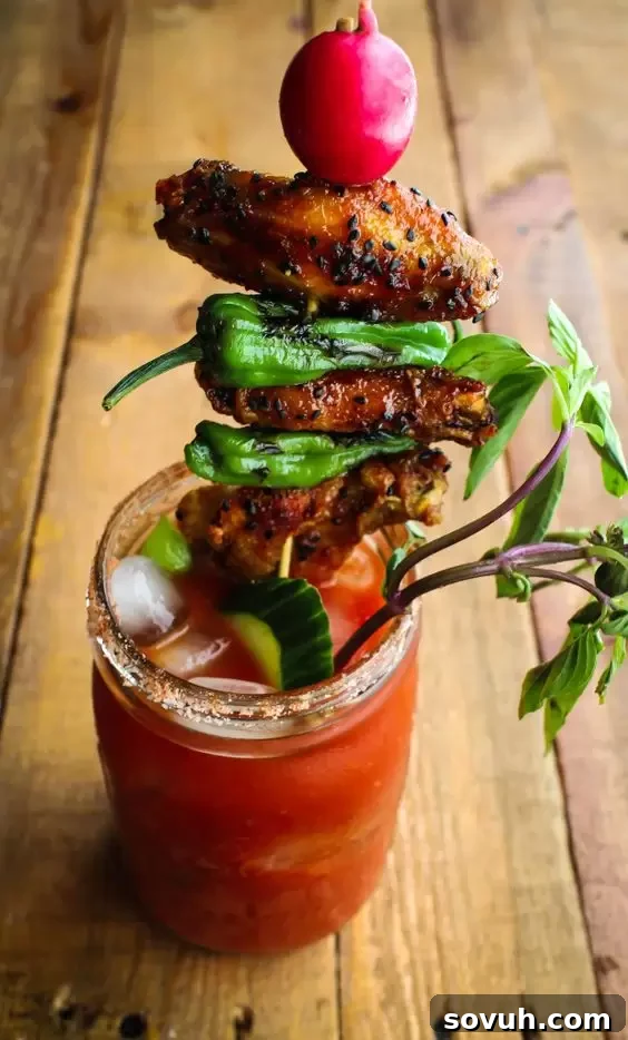 A uniquely flavorful Thai BBQ Bloody Mary, featuring an exotic garnish and a rich, dark hue.
