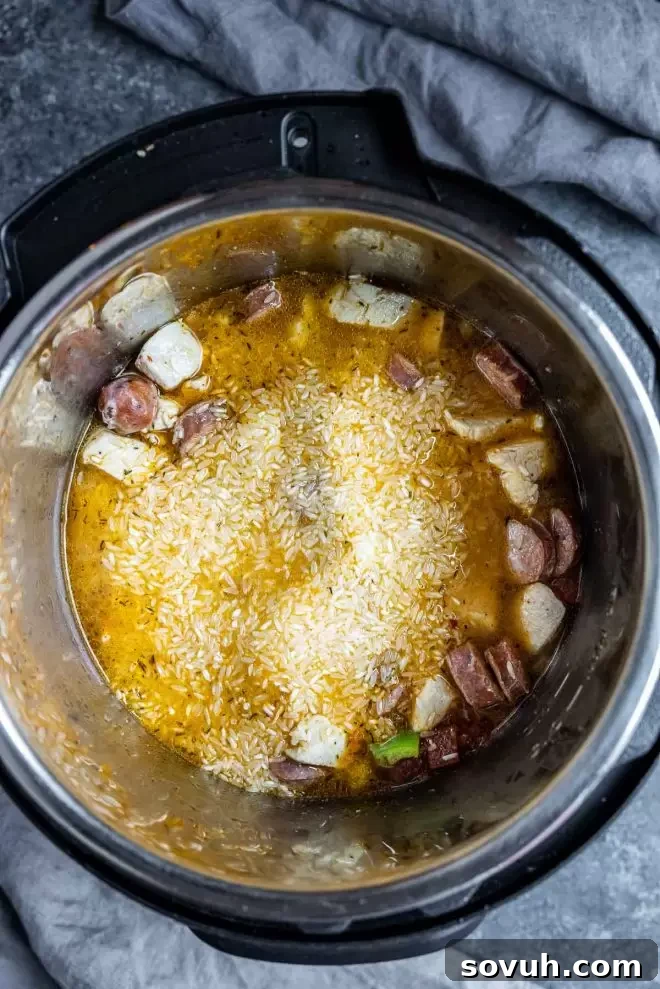 All the fresh ingredients and spices laid out on a cutting board, ready to be combined for Instant Pot Jambalaya.