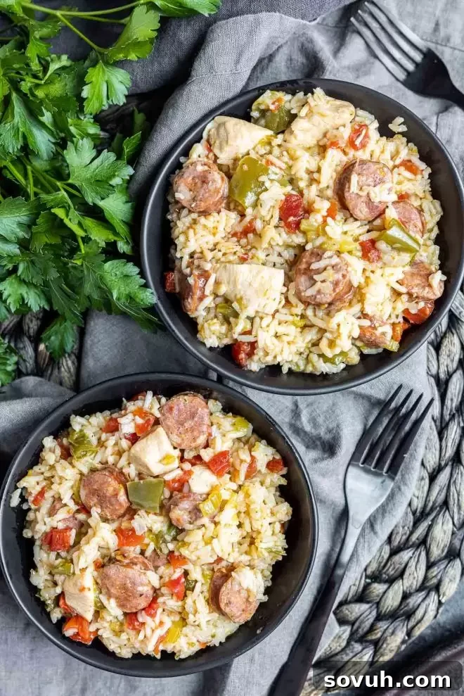 Two bowls of freshly made Instant Pot Jambalaya, garnished with green onions, showcasing a perfect serving.