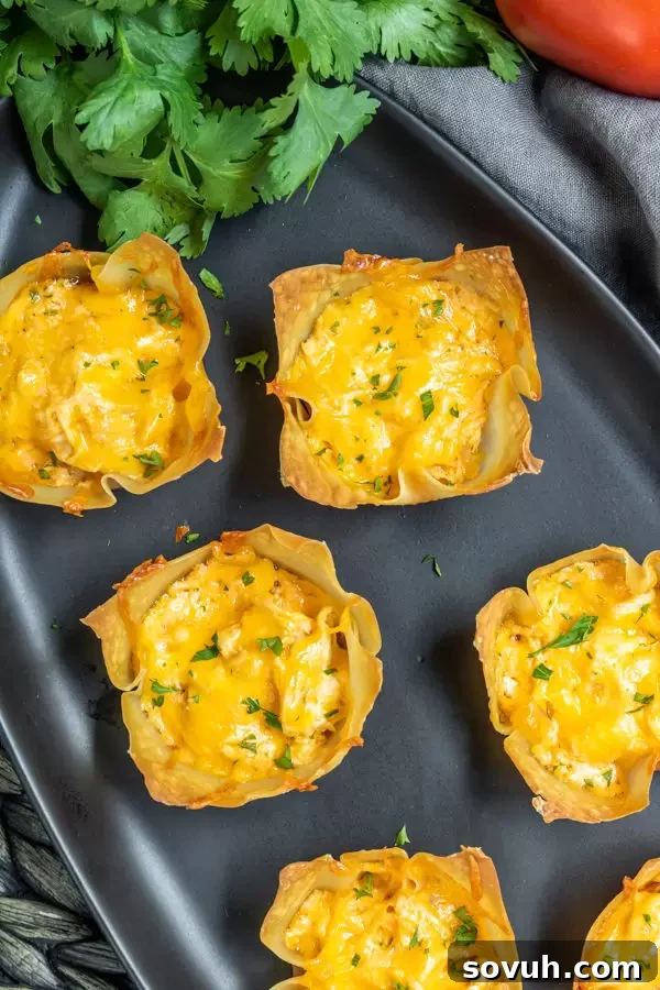 Black platter with baked Buffalo Chicken Cups