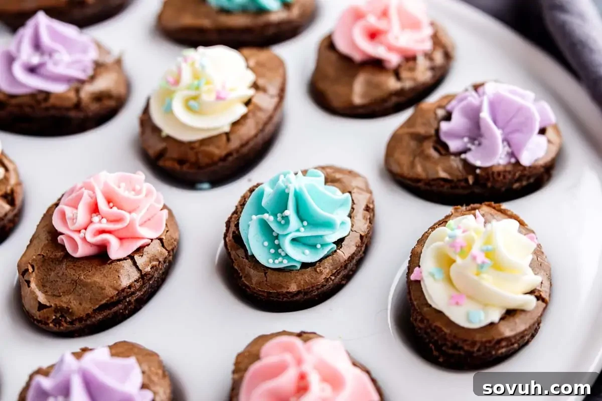 Devilish Easter Brownies from a Box 2 Oval-shaped Easter brownies made from brownie mix dessert, topped with colorful icing and sprinkles, arranged on a white plate.