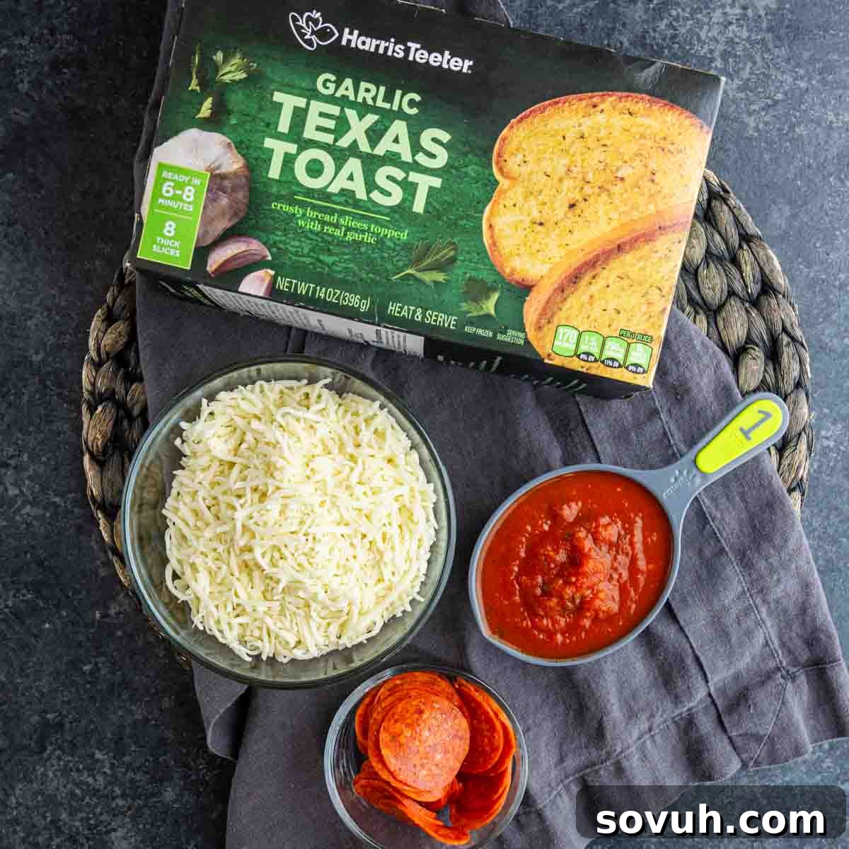 15-Minute Texas Toast Pizza Recipe for Quick Family Dinner 3 A box of garlic Texas toast, a bowl of shredded cheese, a measuring cup of tomato sauce, and a bowl of pepperoni slices on a dark surface—perfect for making an easy pizza toast recipe like Texas Toast Pizza.