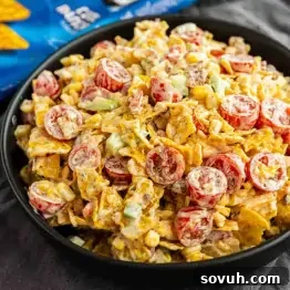 Crunchy Cool Ranch Doritos Salad with Bacon & Sweet Corn 7 A bowl of Cool Ranch Doritos Salad with cherry tomatoes, corn, celery, cheese, and chips, all tossed in a creamy dressing.