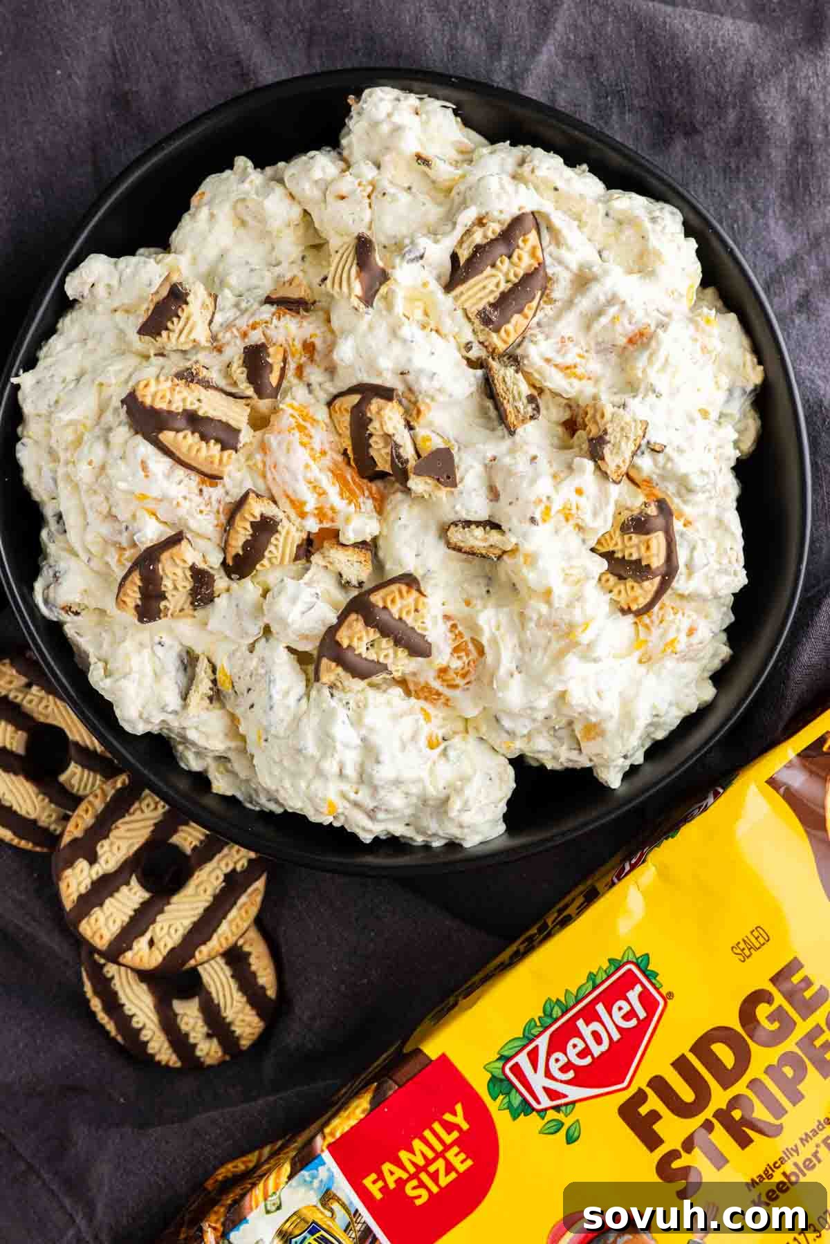 Fudge Stripe Cookie Salad Recipe: Creamy No-Bake Dessert 6 A bowl of creamy Fudge Stripe Cookie Salad topped with pieces of Keebler Fudge Stripes cookies, with whole cookies and a package of Keebler Fudge Stripes beside the bowl—an easy Cookie Salad perfect for any sweet craving.