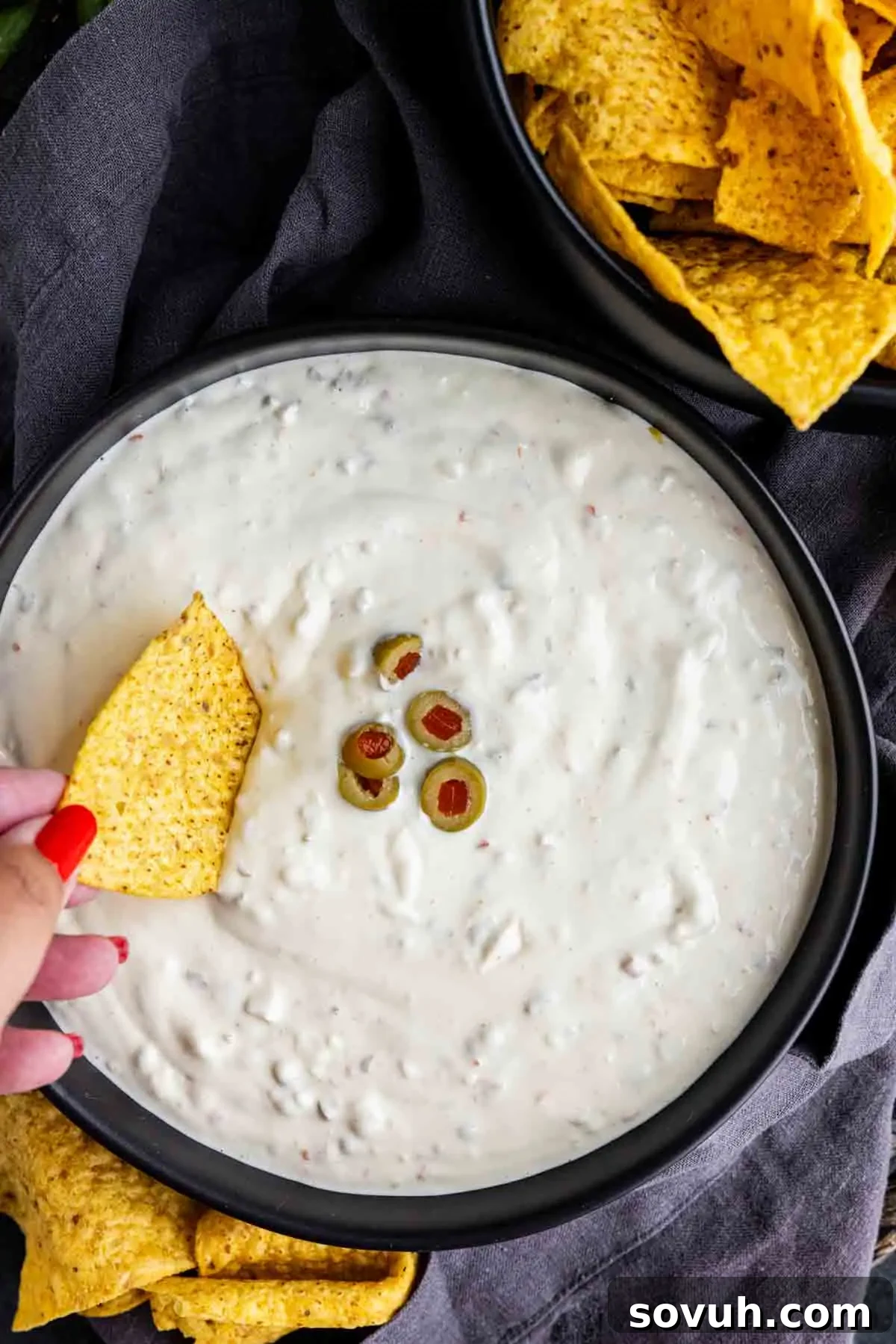 Hamlin’s White Dip served in a bowl with tortilla chips and chopped green olives